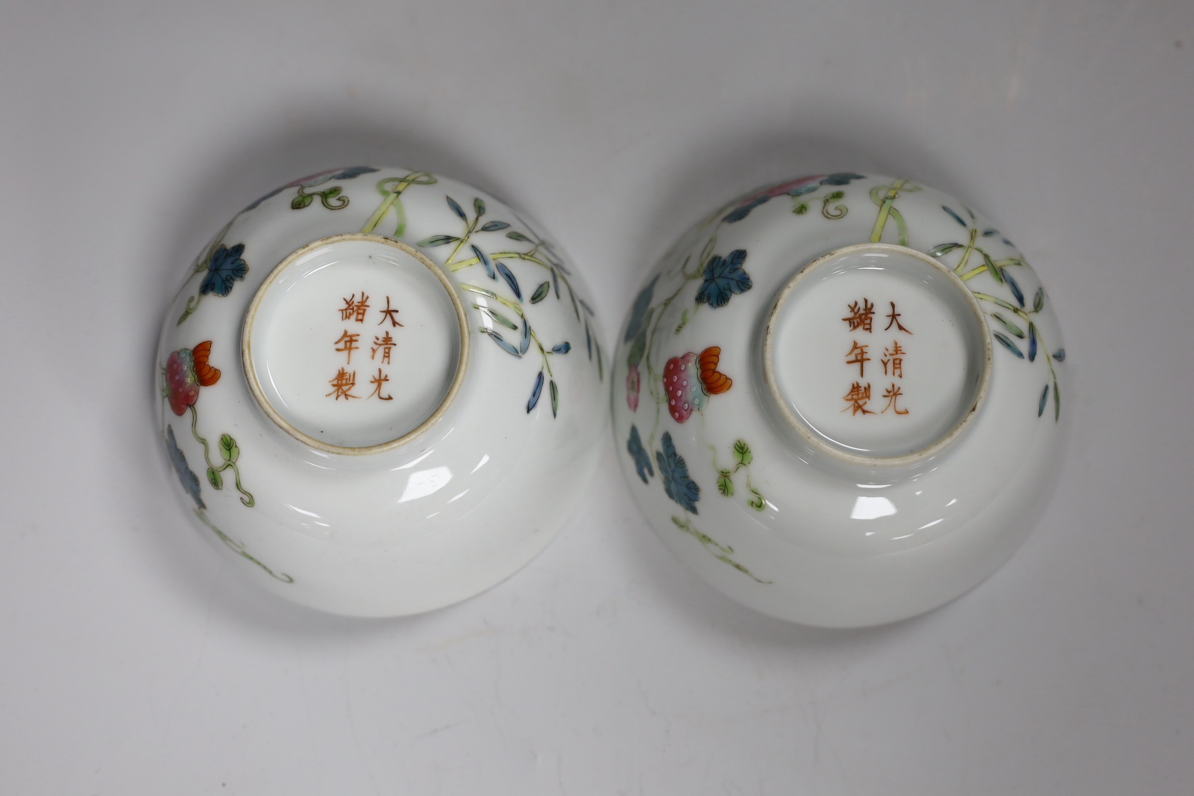 A pair of Chinese famille rose bowls and two similar saucer dishes